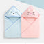 Two plush hooded baby towels shown side by side on a clean white background. The left towel is light blue with a bunny-ear hood and a simple bunny face.